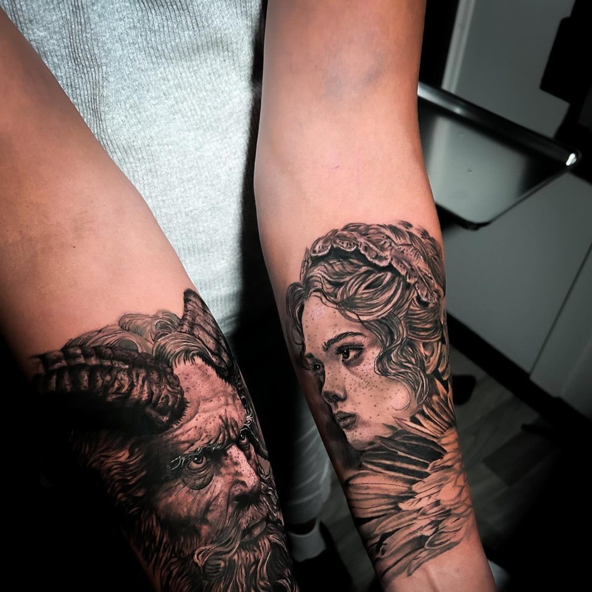 Angel and Demon Tattoo: 8 Photo Ideas for Your Next Ink 7 Two detailed black and grey tattoos on a person's forearms, featuring a woman and a demon.