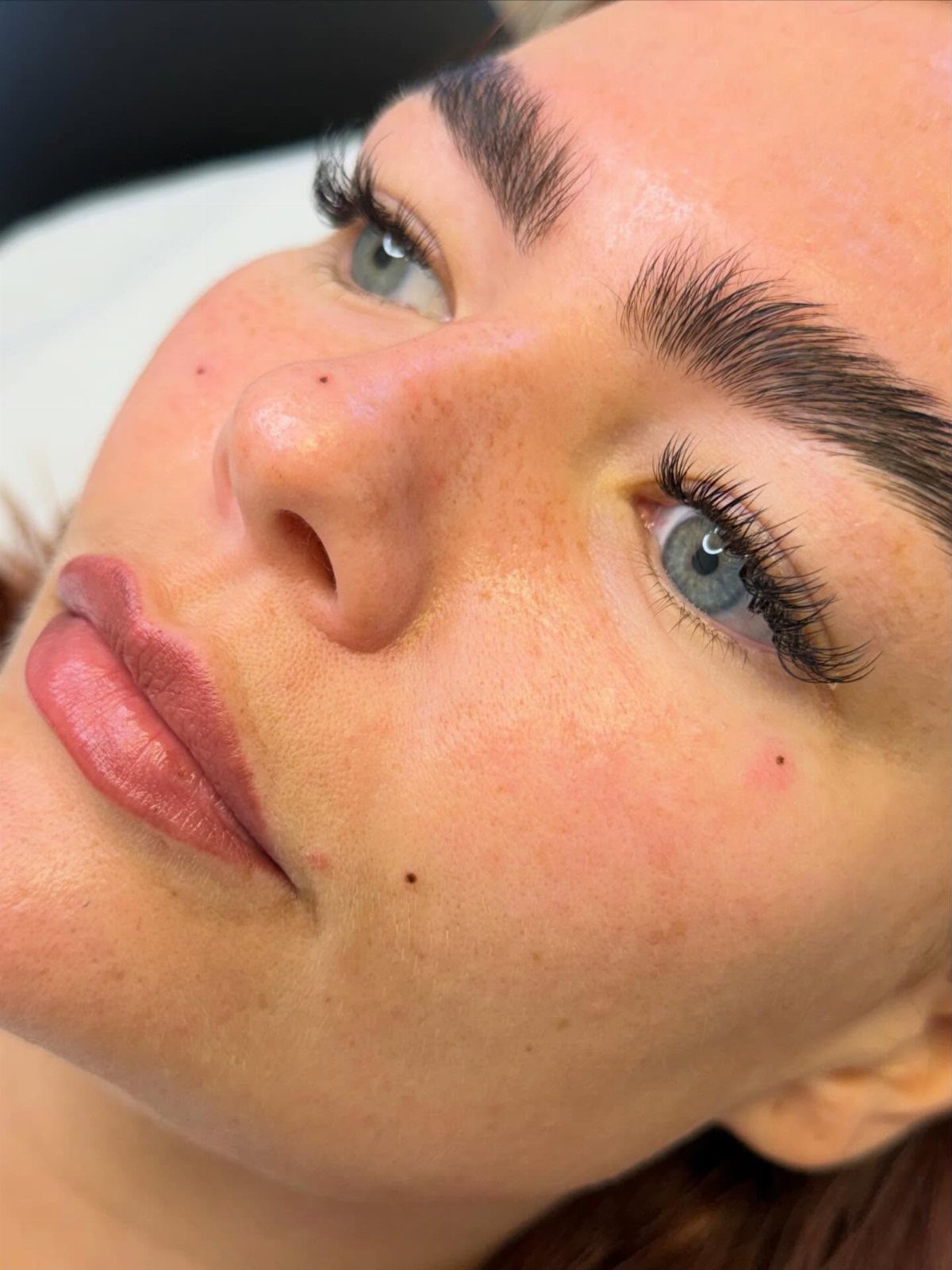 Beauty Mark Tattoo: 5 Placement Ideas for Every Face 1 Close up of a woman's face featuring several small beauty marks on her skin.