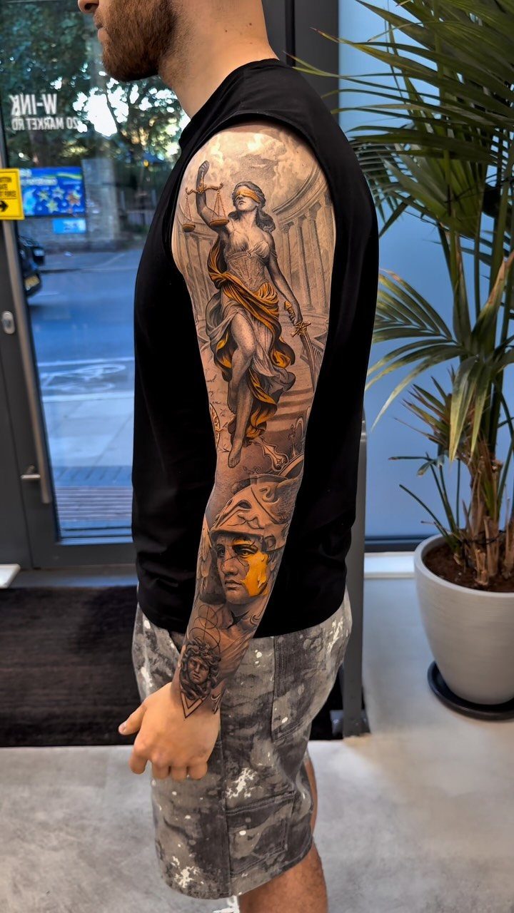 Fine Line Tattoo Sleeve: 10 Ideas With Photos 9 A man's arm displaying a detailed fine line tattoo sleeve with classical mythological figures.