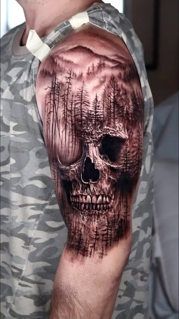 11 Forest Theme Tattoo Ideas: Wolf, Mountain, Sleeve & More 7 A large black and grey tattoo of a skull merged with a pine forest on an arm.