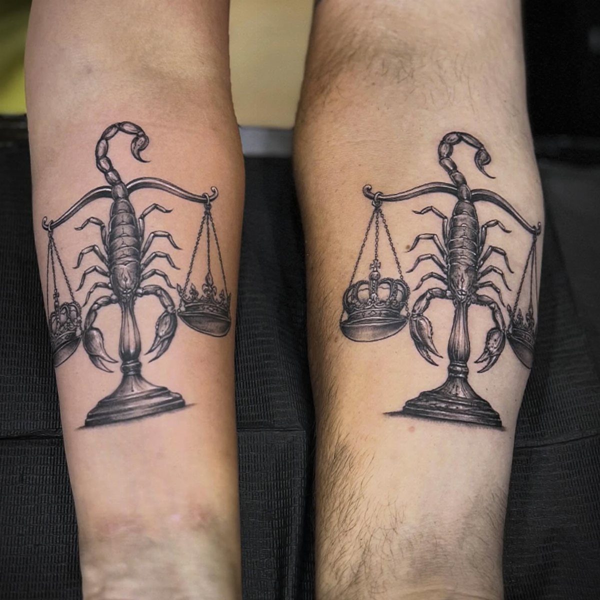 Good vs Evil Tattoo: 8 Designs That Split Skin Between Sides 2 Two black and grey scorpion and scales tattoos on human forearms with crowns.