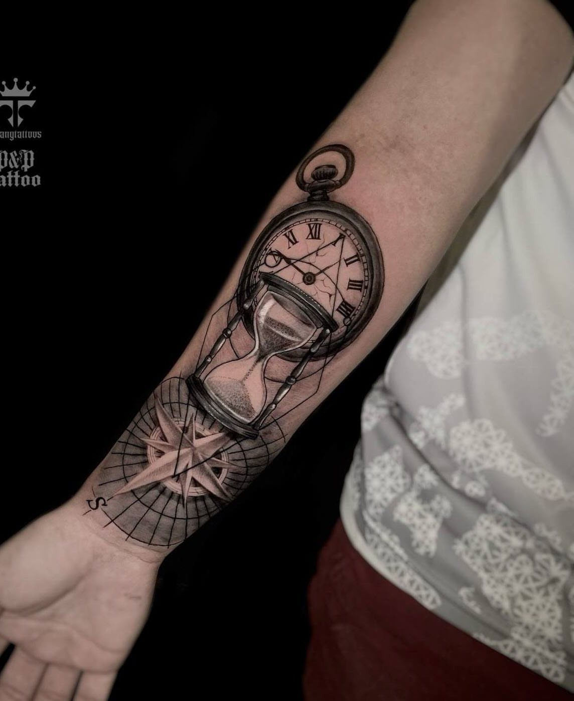Hour Glass Tattoo Ideas: 12 Designs for Every Style 8 A black and grey forearm tattoo depicting an hourglass, clock face, and a compass rose.