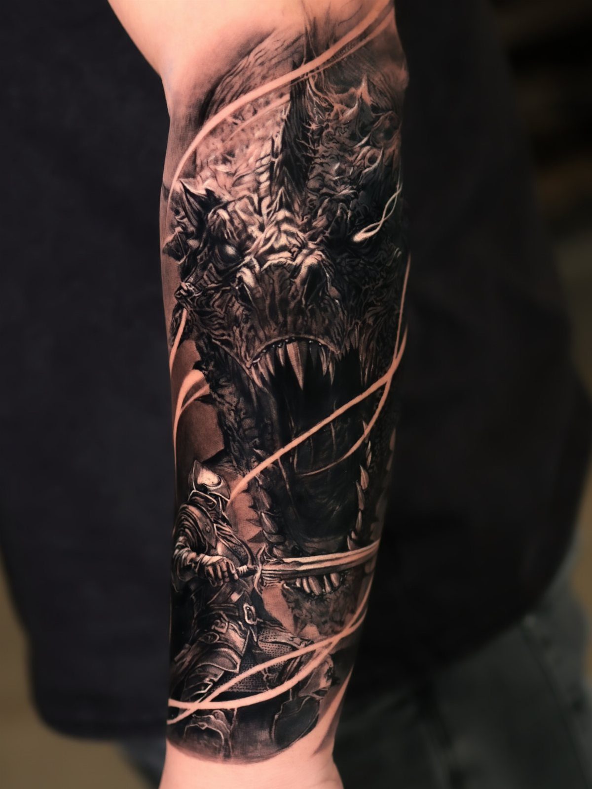 7 Knight Style Tattoo Ideas for 2026 7 A detailed black and grey tattoo of a knight facing a massive roaring dragon on a forearm.