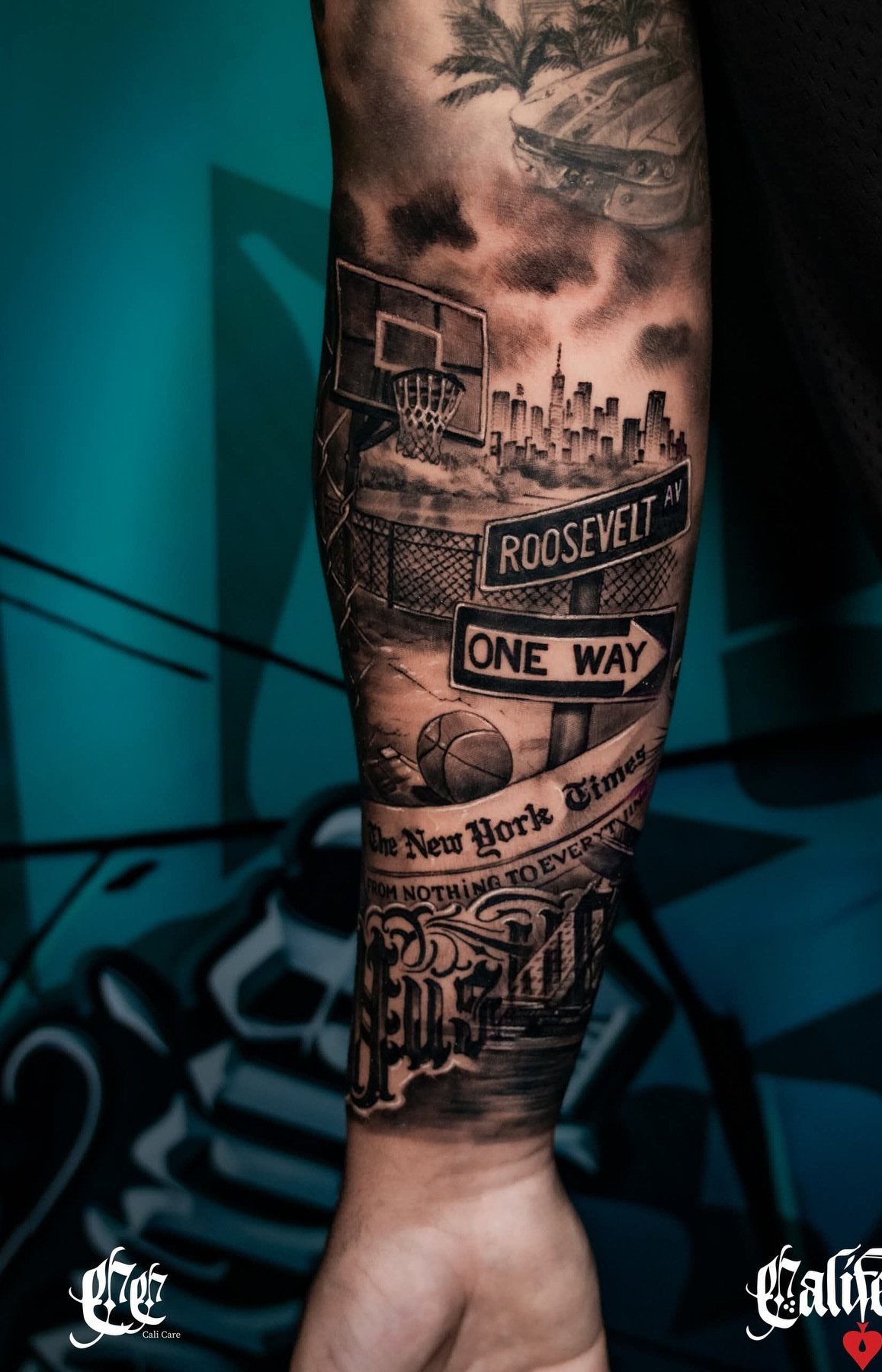 A detailed black and grey urban landscape tattoo on a person's forearm.