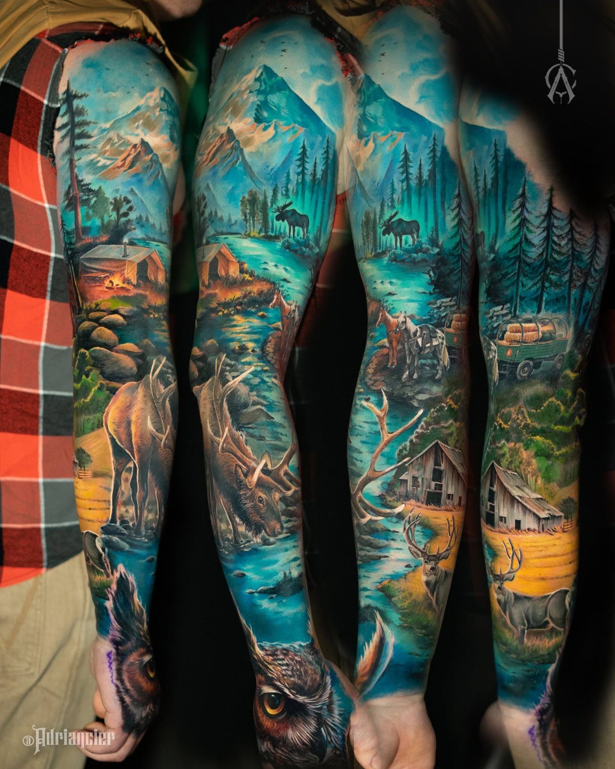 7 Landscape Tattoo Sleeve Ideas for Your Next Ink 5 A detailed tattoo sleeve on an arm depicting mountain landscapes, forests, and various animals like moose and deer.