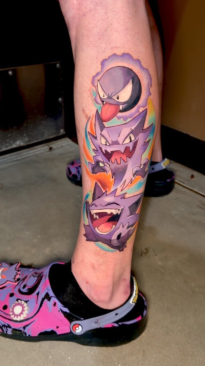 5 Leg Tattoo Template Ideas: From Printable to Full Leg Sleeve 3 A colorful Pokemon tattoo featuring Gengar on the side of a person's lower leg.
