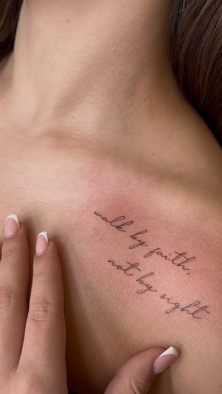 Script Tattoo Placement: 9 Positions That Work 4 A script tattoo reading 'walk by faith, not by sight' on a person's collarbone.