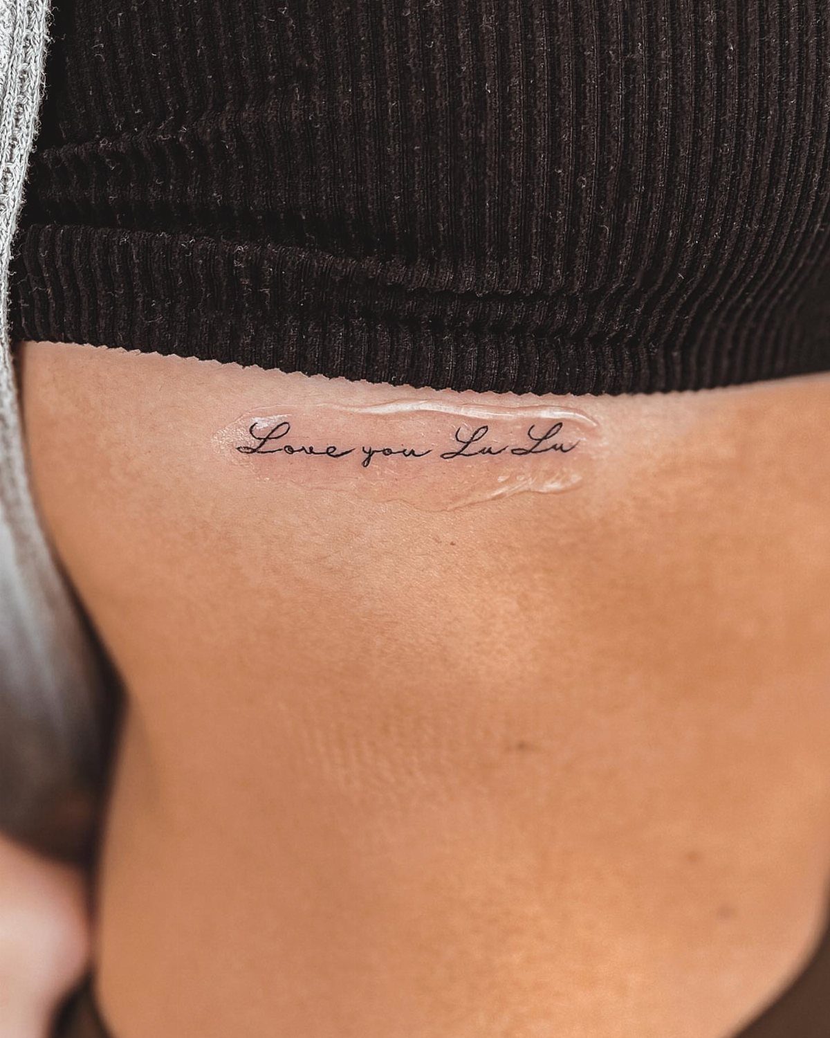 Script Tattoo Placement: 9 Positions That Work 1 A small script tattoo reading Love you Lu Lu on a person's ribcage.