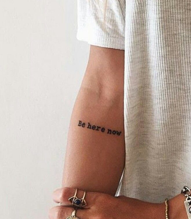 Script Tattoo Placement: 9 Positions That Work 5 A person's inner forearm displaying a small black script tattoo reading Be here now.