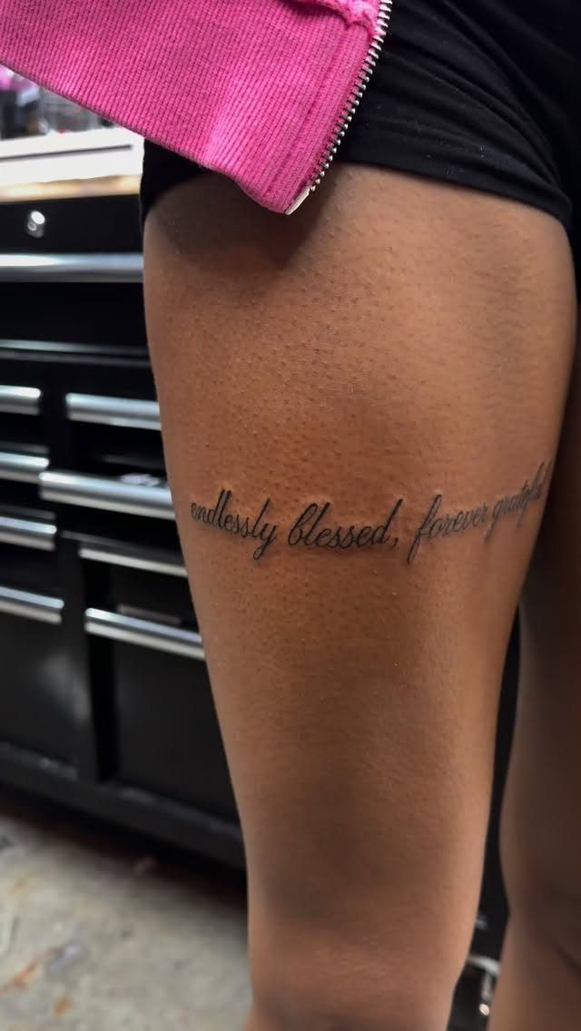Script Tattoo Placement: 9 Positions That Work 8 A script tattoo reading endlessly blessed, forever grateful on a person's thigh.