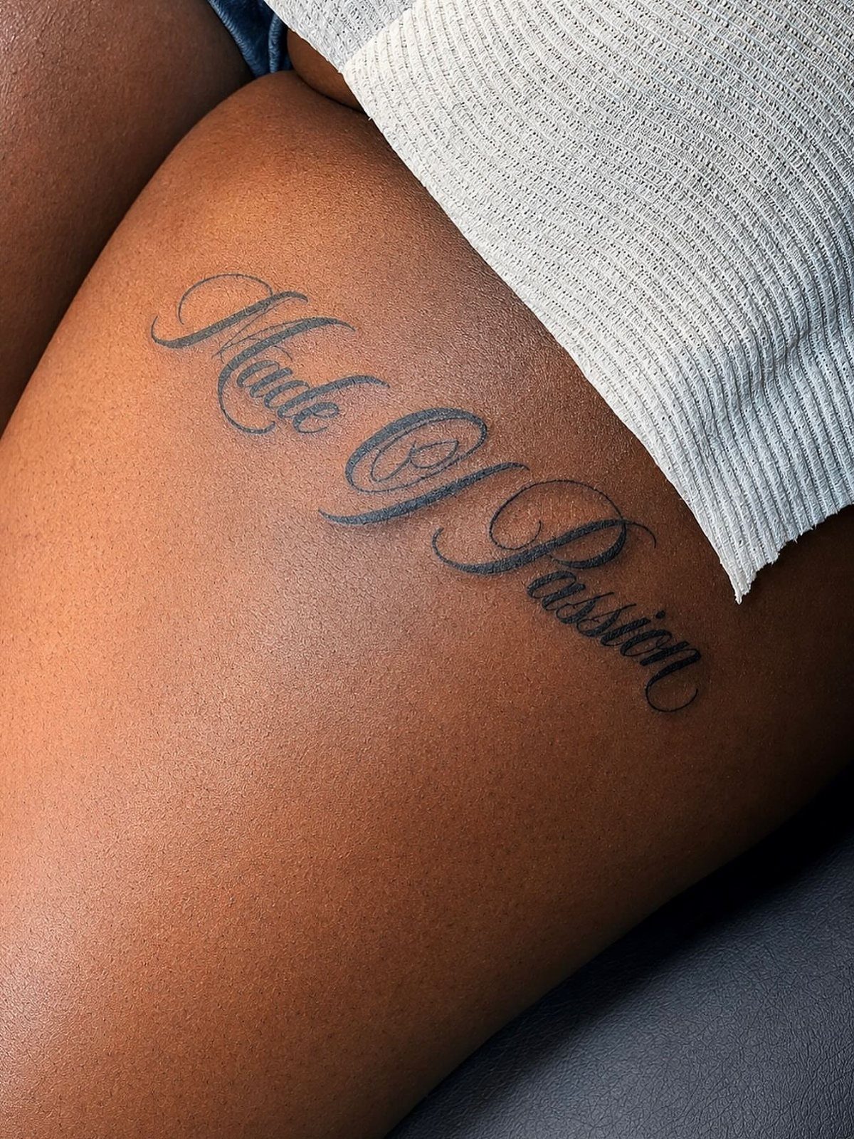 Script Tattoo Placement: 9 Positions That Work 2 A script tattoo reading Made Of Passion on a person's upper hip skin.