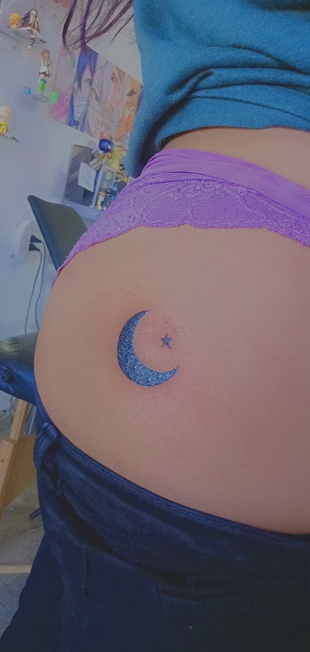 Star Tattoo on Hip: 6 Fresh Ideas for Placement and Style 6 A small blue crescent moon and star tattoo on a person's hip skin.