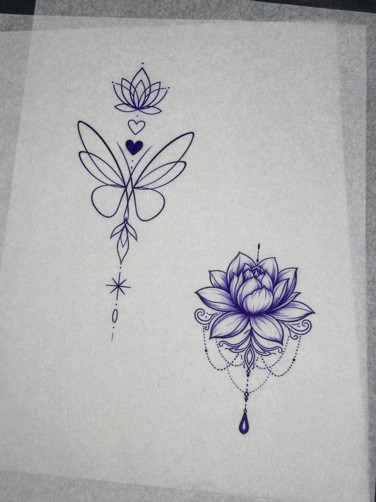 Stencil Tattoo Ideas: 14 Designs for Artists and First-Timers 1 Two purple ink tattoo designs featuring a butterfly and a lotus on transfer paper.