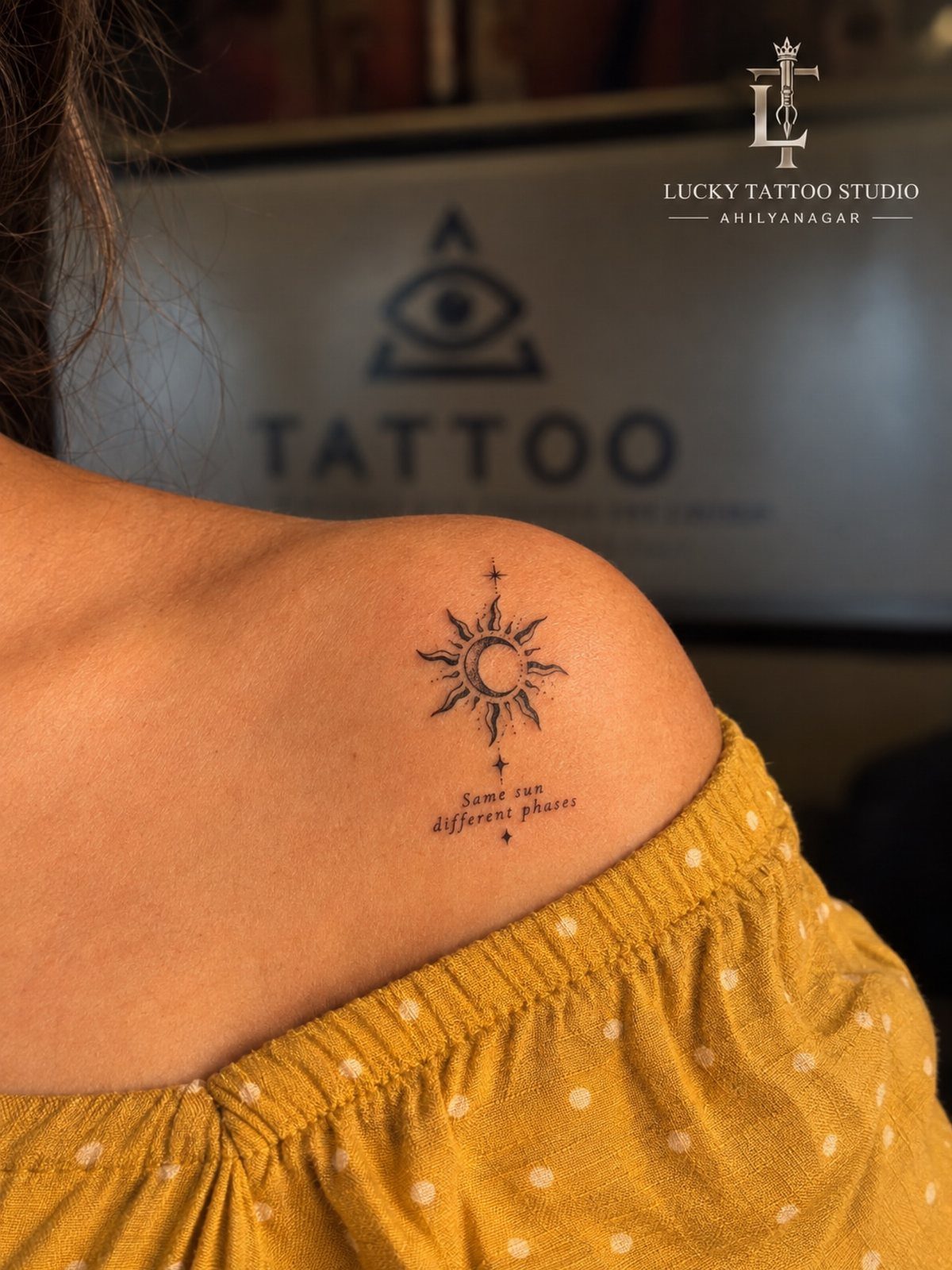 10 Tattoo Style Nature Ideas for Your Next Session 4 A fine line sun and moon tattoo on a person's shoulder with small text below.
